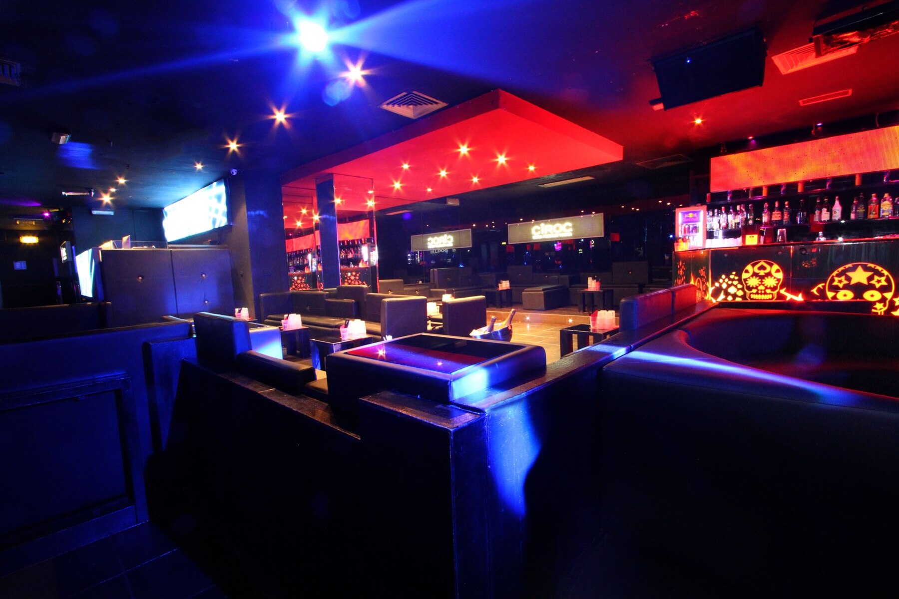 The Club Milano's lounge, glowing in red and blue neon, where Amanda & Mattia are hosting one last wedding toast