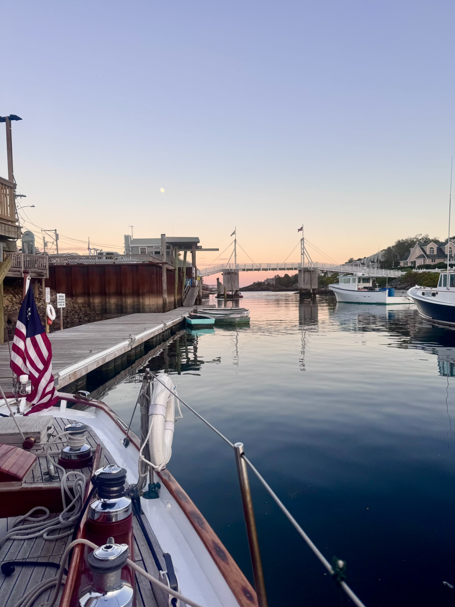 The harbor at dusk, moon rising over the bridge