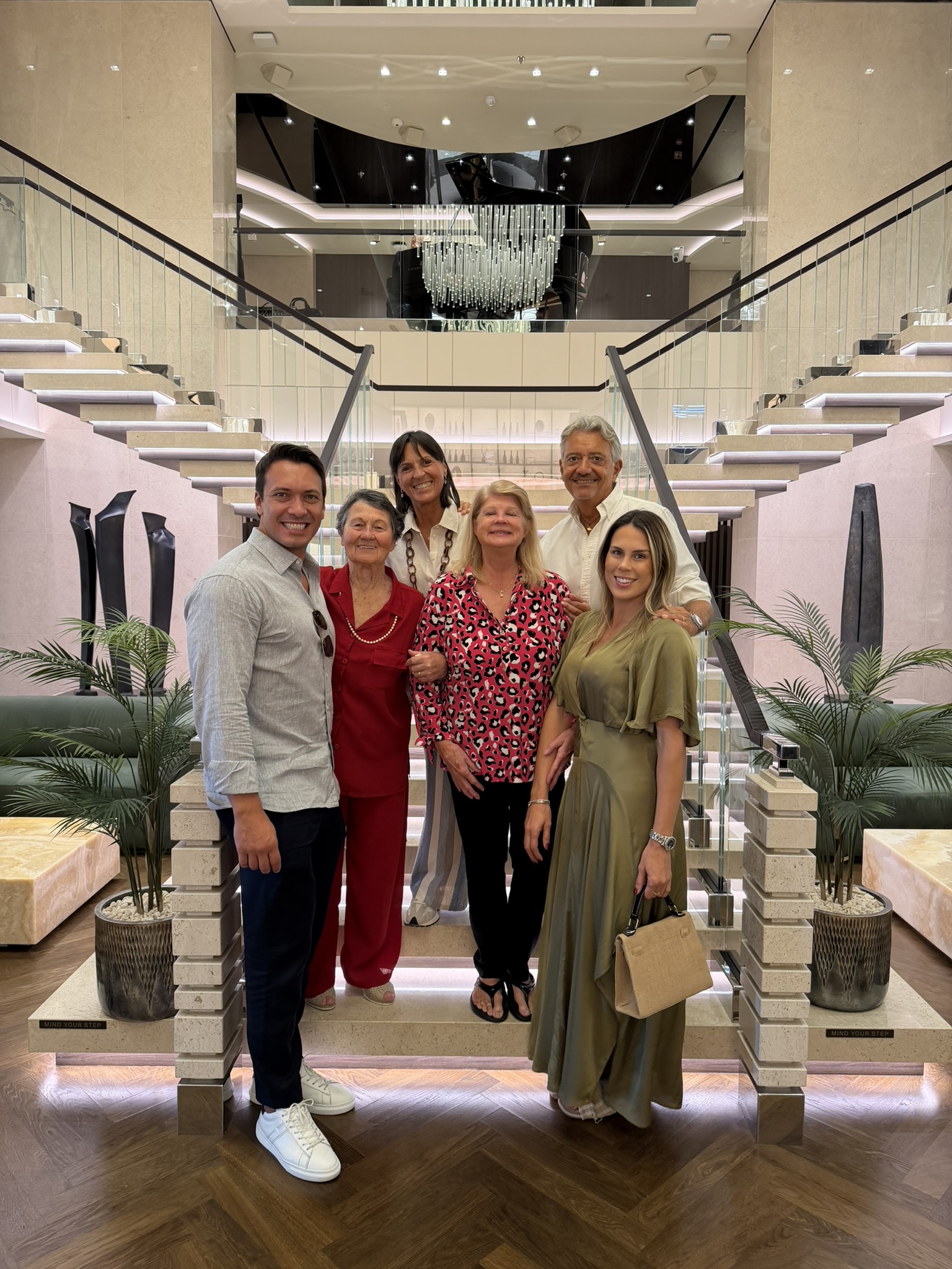 Family gathered on the grand staircase of the cruise ship