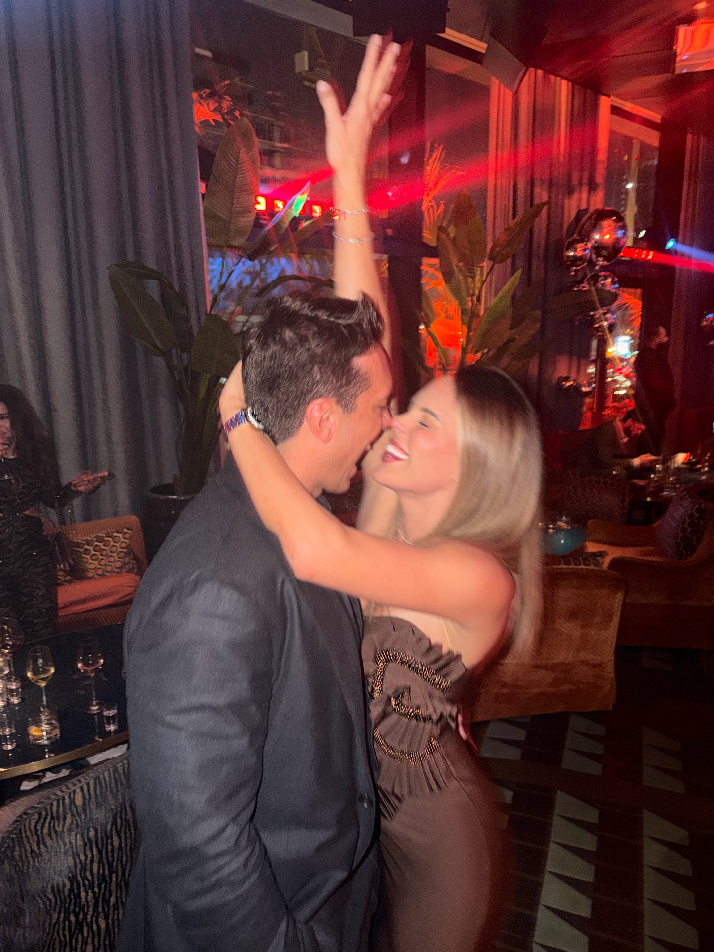 A kiss under the red lights at the club