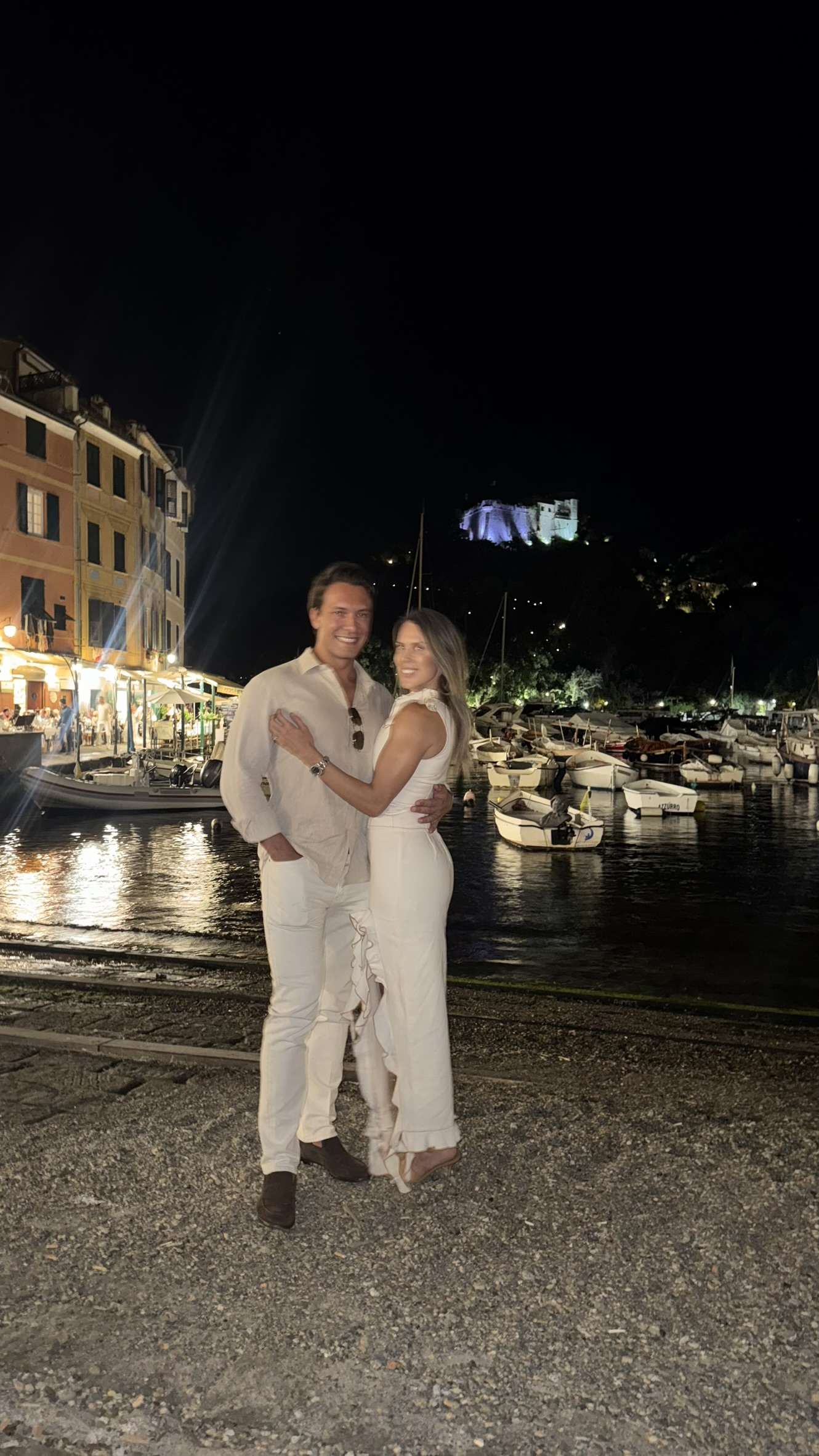 An embrace by the Portofino harbor at night