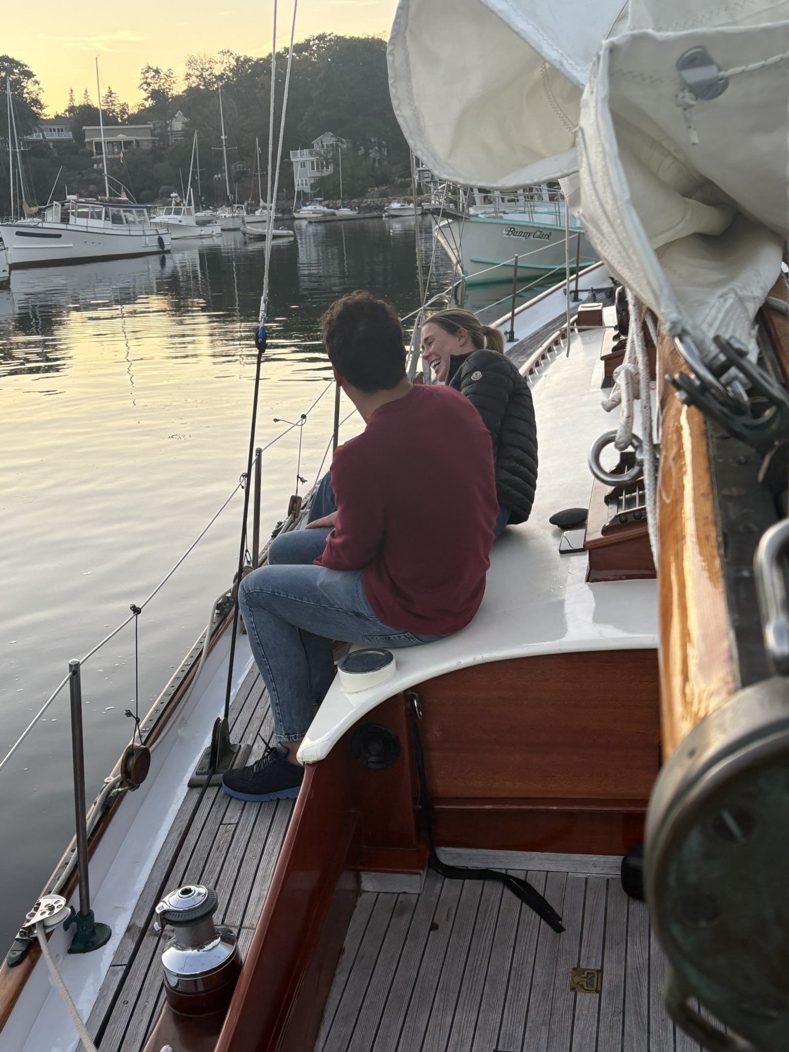 Laughing on the bow at sunset