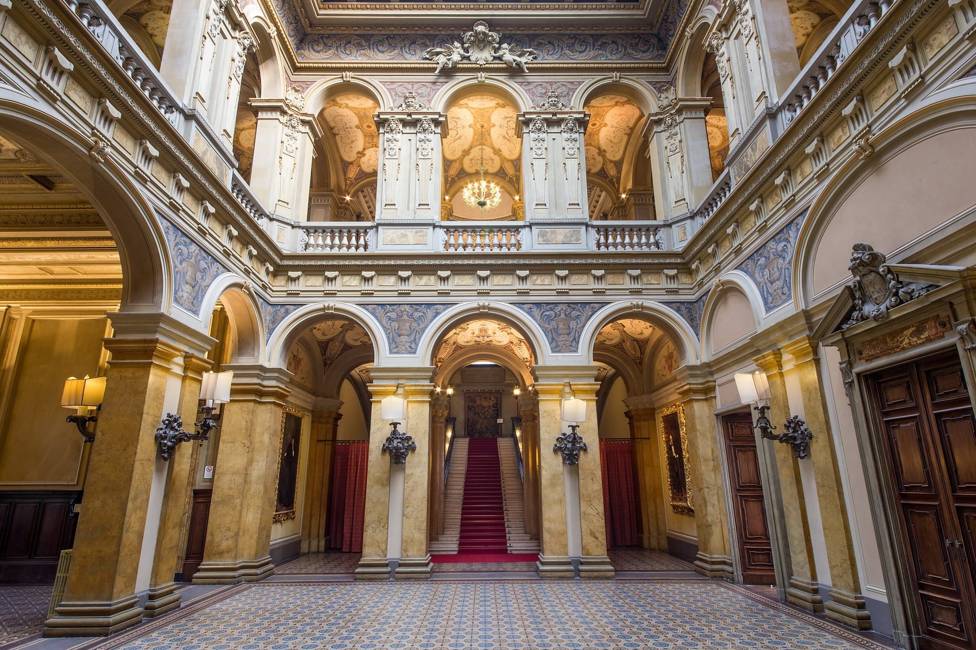 A frescoed ballroom at Villa Erba with a crystal chandelier